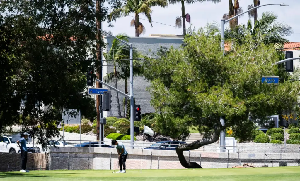 Golfers putt on hole 8 at the corner of Mesa...