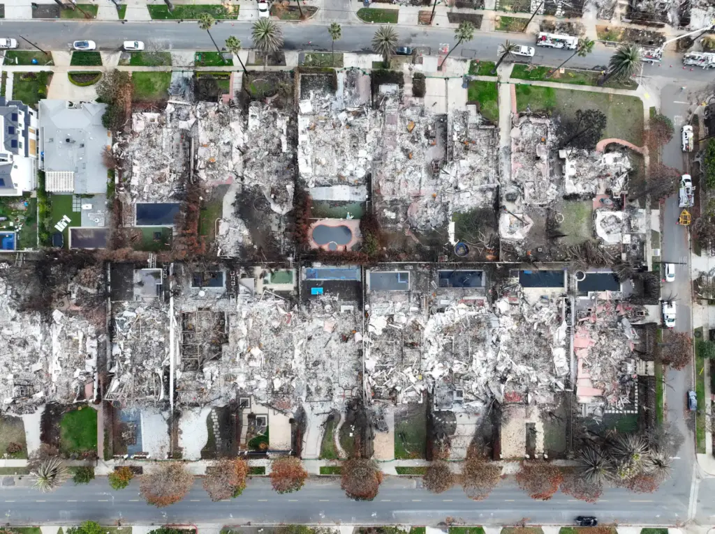 Aftermath of the Palisades Fire looking down at homes between...