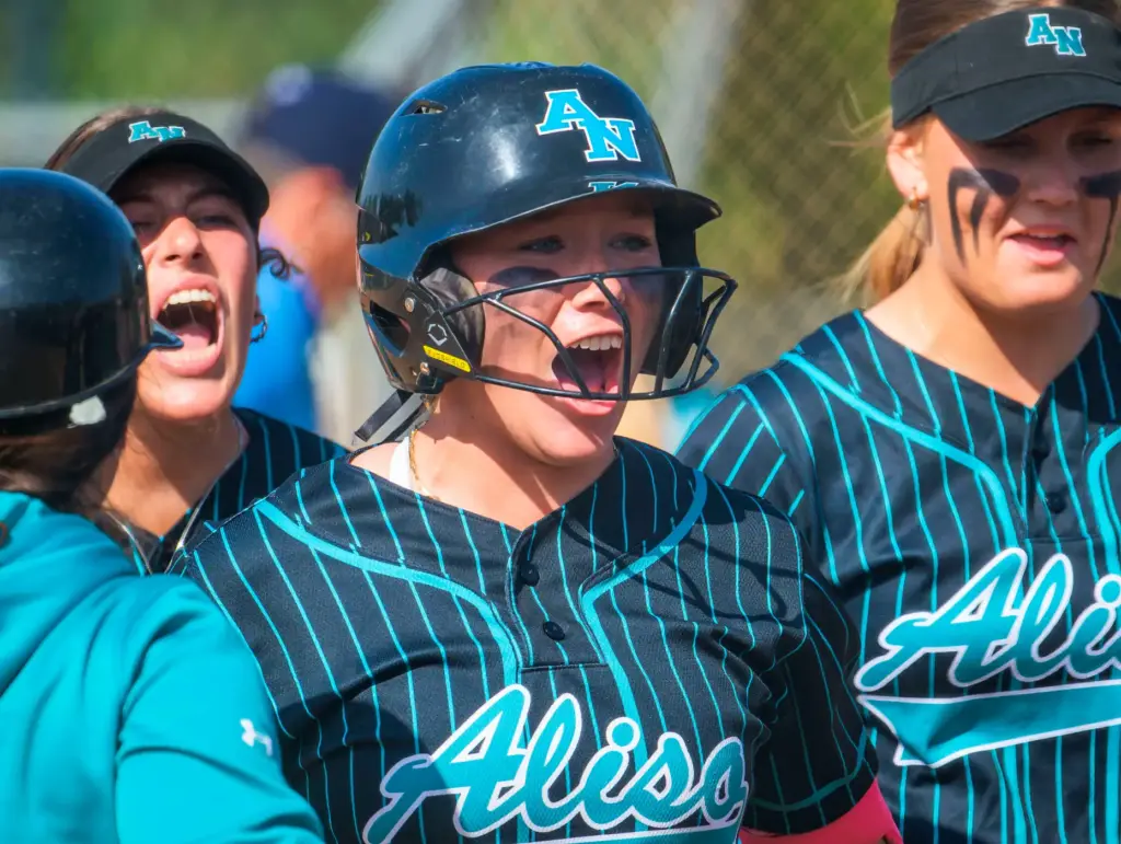 Aliso Niguel’s Tessa Cowsill celebrates with teammates after hitting a...