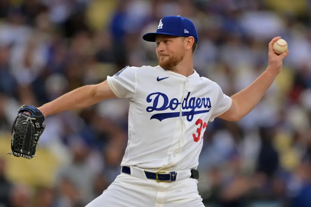 Dodgers starting pitcher Eric Lauer throws to the plate during...