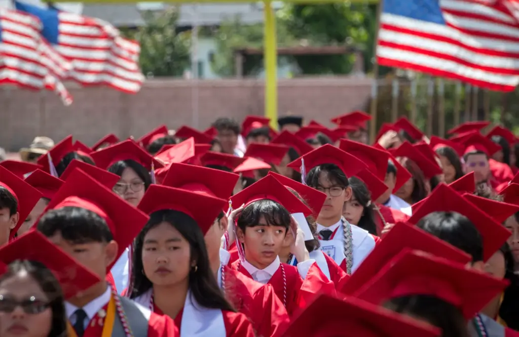 A graduate adjusts his cap during the Garden Grove High...