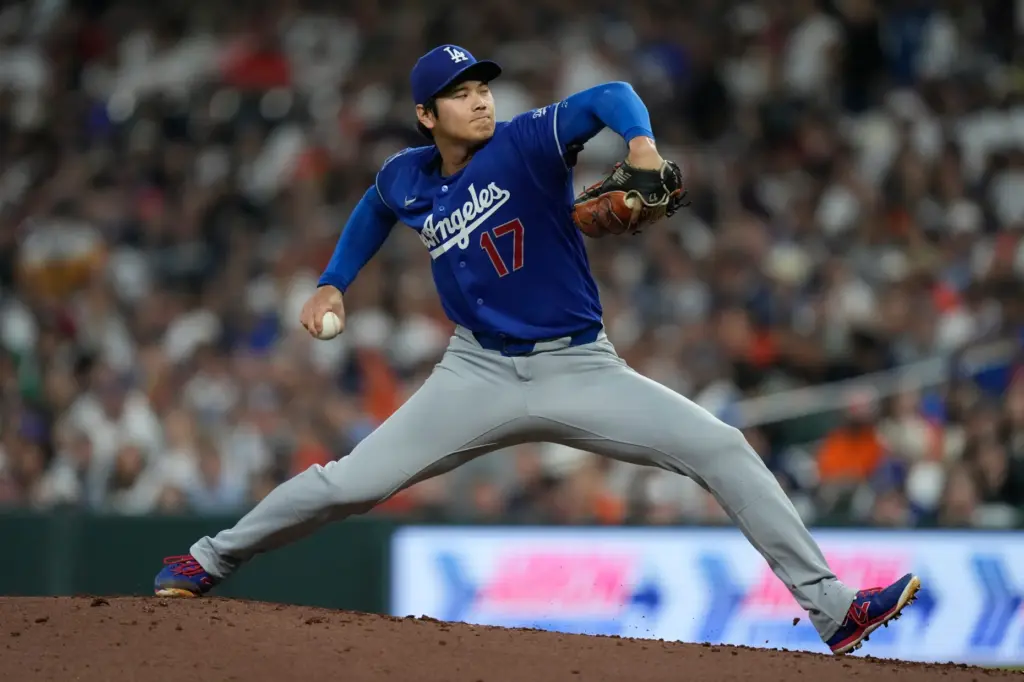 Dodgers starting pitcher Shohei Ohtani throws to the plate during...