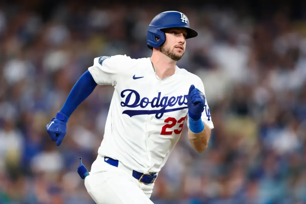 The Dodgers’ Kyle Tucker runs after hitting an RBI double...