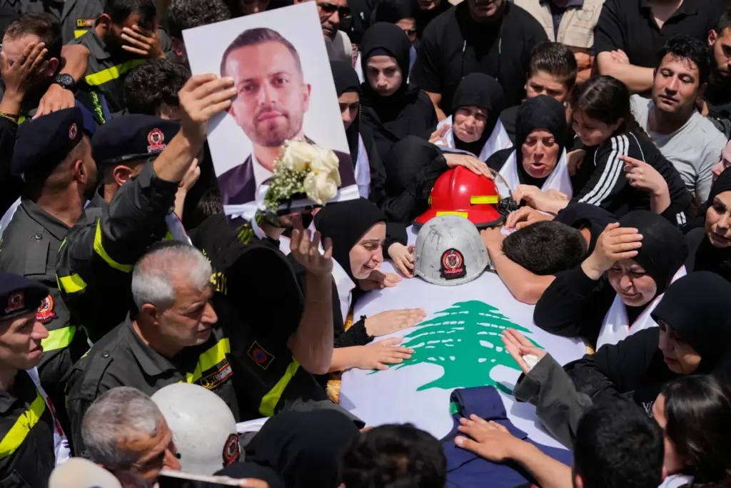 Mourners react over the coffin of Lebanese Civil Defense member,...