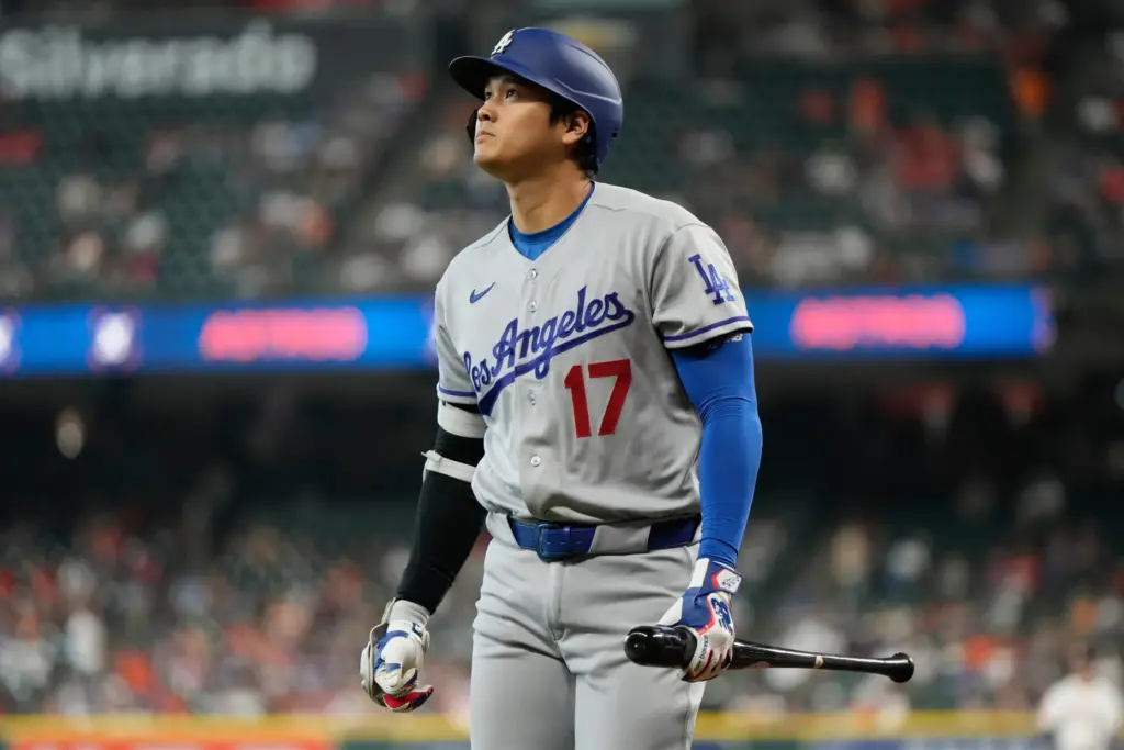 Dodgers star Shohei Ohtani reacts after striking out during the...
