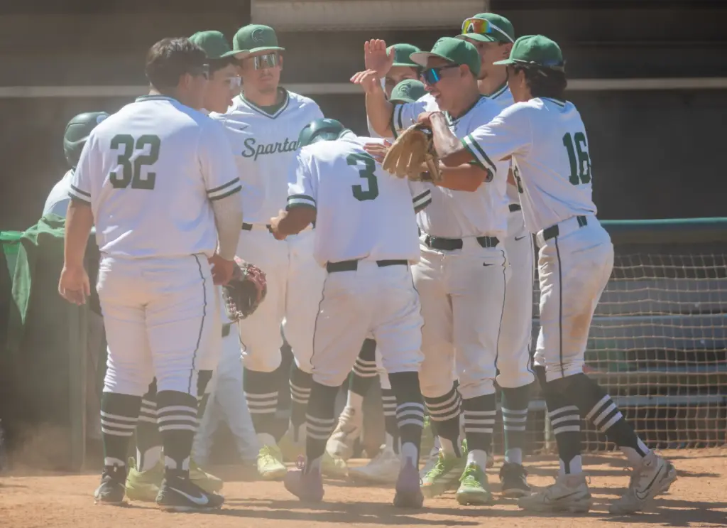 Schurrâs Derek Flores, (#3), is congratulated by teammates after scoring...