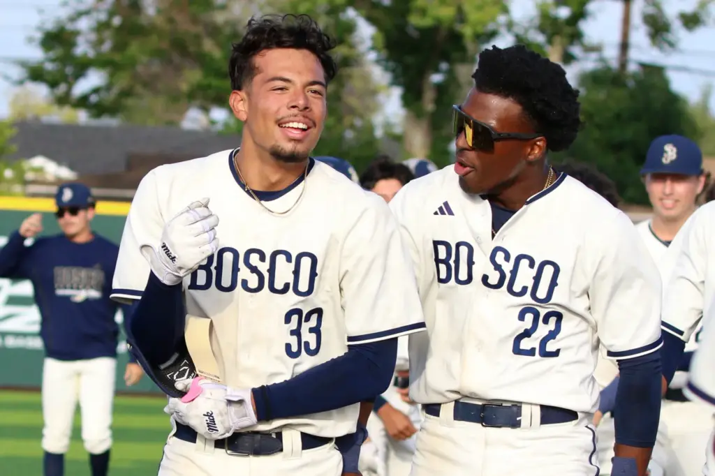 St. John Bosco’s Moises Razo, left, celebrates with teammate James...