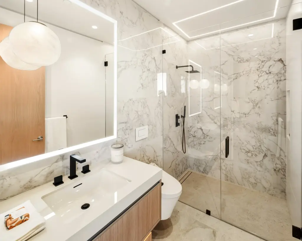 Spanish porcelain and full-height imported wall finishes adorn the secondary...