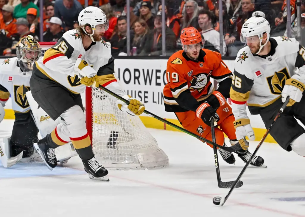 The Ducksâ Troy Terry (19) battle for the puck with...