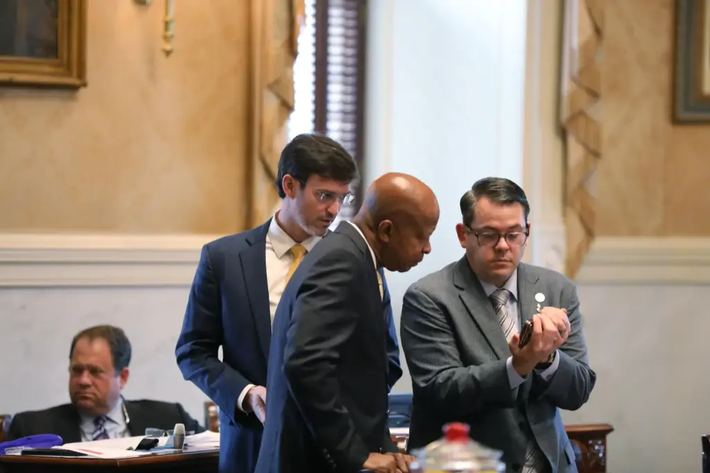 South Carolina Senators look at a phone