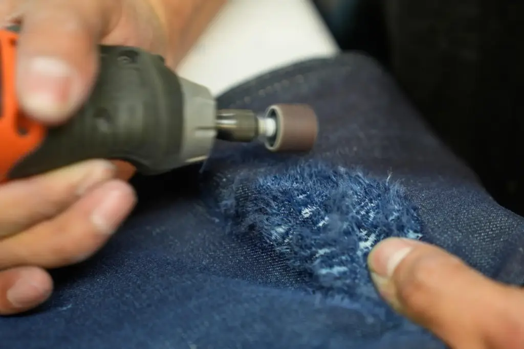 Bryan Morales Ibarra distresses denim by hand at the BPD...