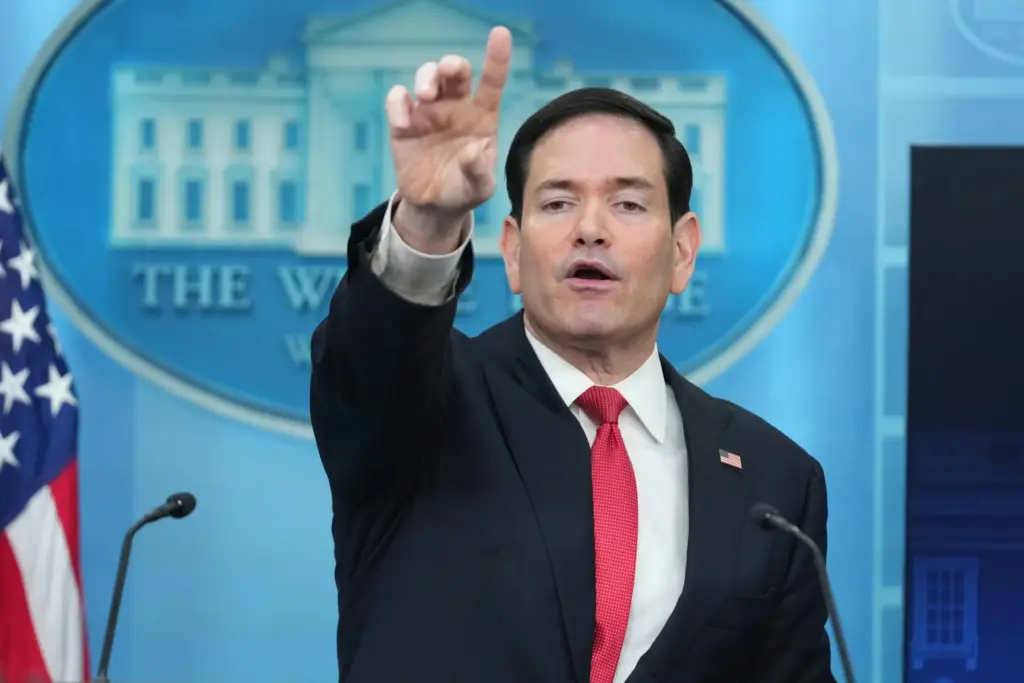 Secretary of State Marco Rubio points to a reporter to...