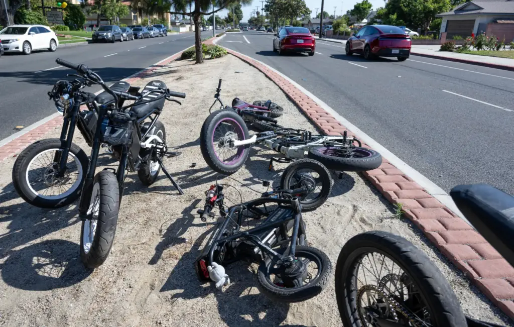 E-riders park their bikes on the median at Magnolia Street...