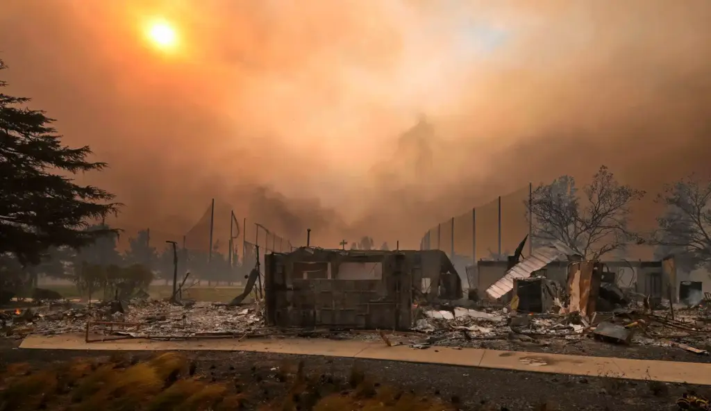 Smoke shrouds the sun as it rises above the Altadena...