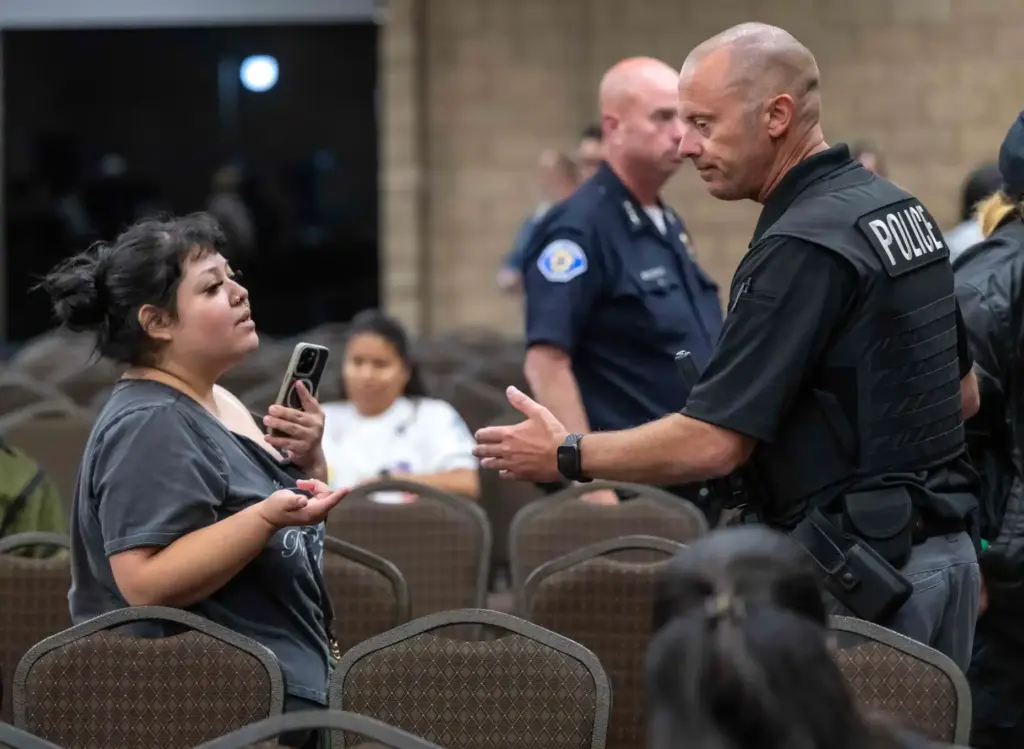 Garden Grove police officers work to clear the room after...