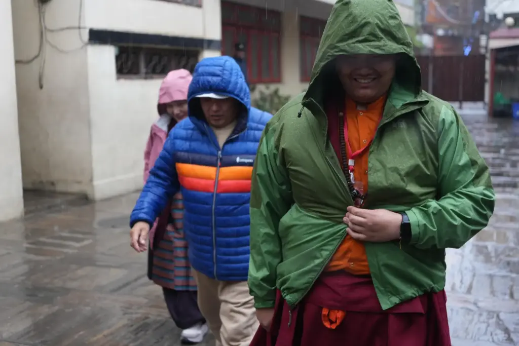 U.S.-born Buddhist lama Jalue Dorje walks in the rain with...
