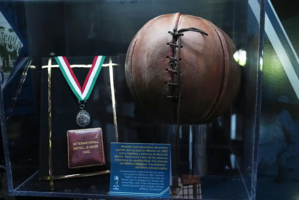 A soccer ball and a medal from 1902 are on display