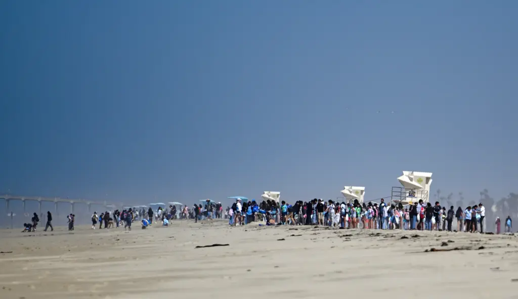 Students shower the beach for trash during Orange County Coastkeeperâs...