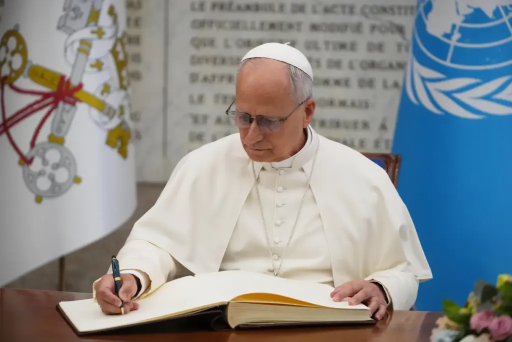 Pope Leo XIV signs the FAO Golden Book register of honor.