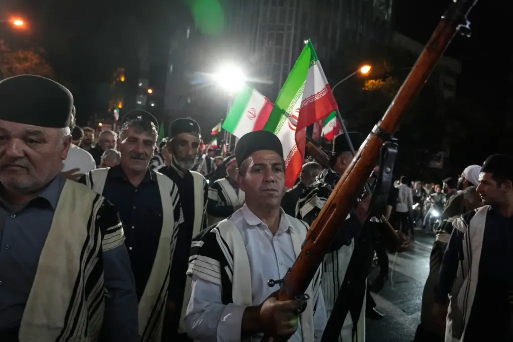 Bakhtiari nomads chant slogans as one of them holds a gun during a pro-government gathering.