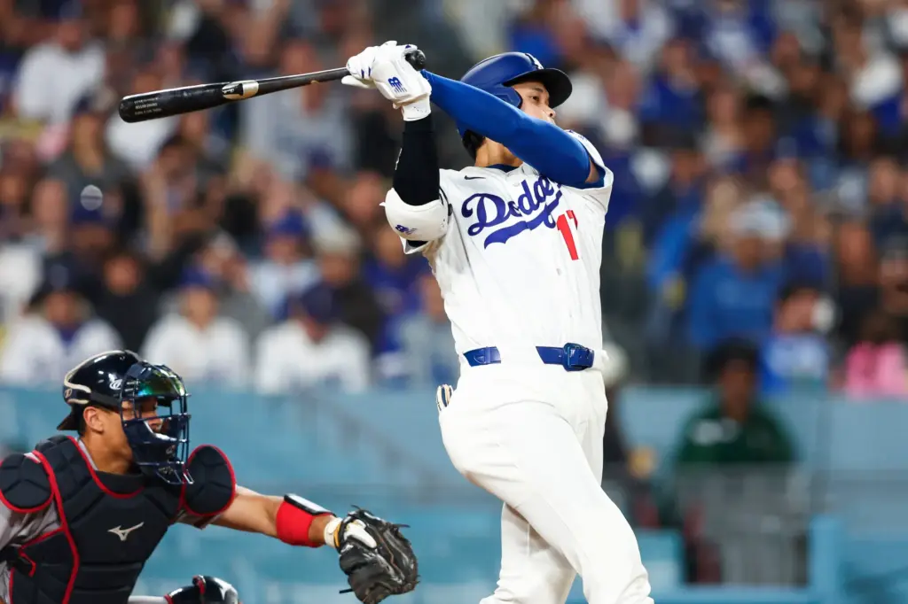 Dodgers star Shohei Ohtani hits an RBI single during the...