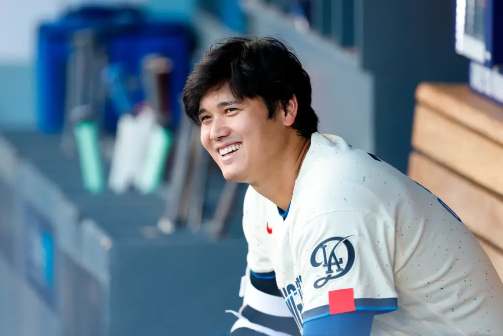 Dodgers designated hitter Shohei Ohtani (17) talks with teammates ahead...