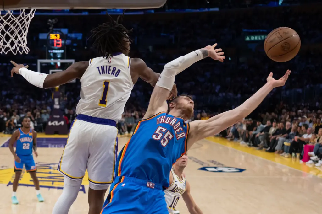 Oklahoma City Thunder center Isaiah Hartenstein, right, and Lakers forward...