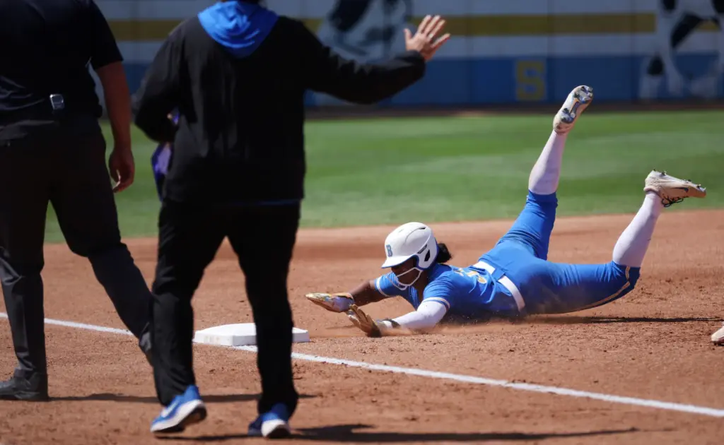 UCLAâs Kaniya Bragg slides into third base during the NCAA...
