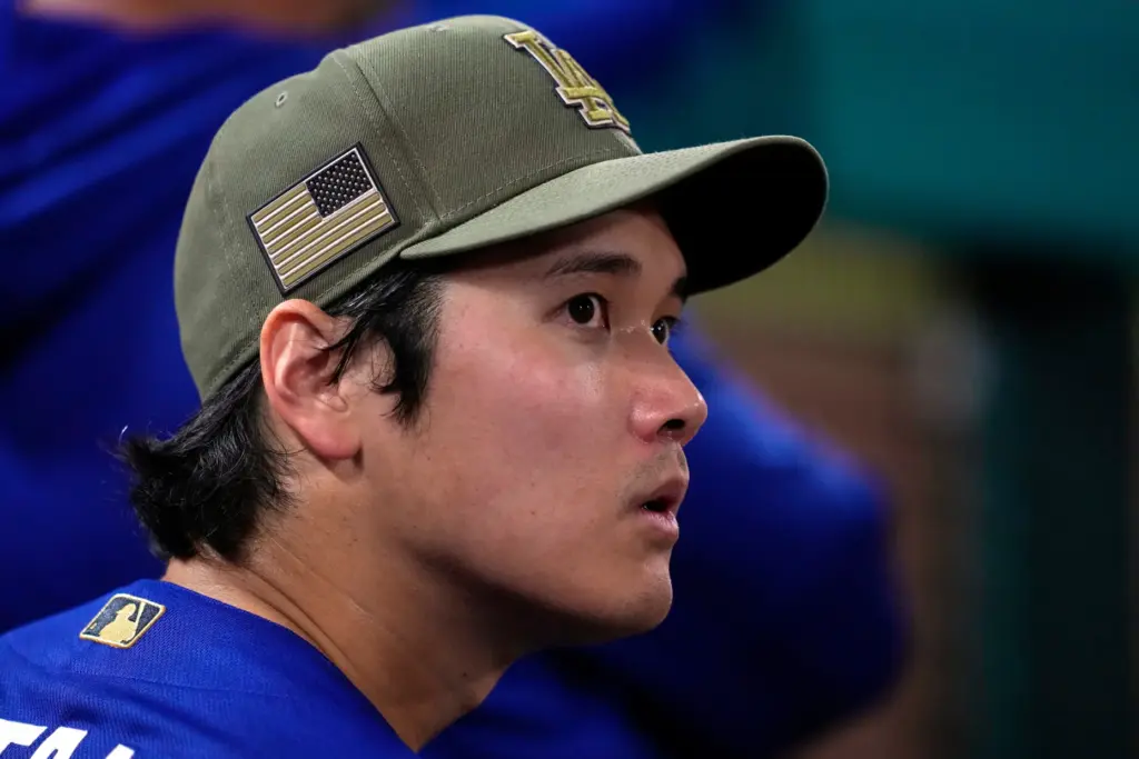 Dodgers star Shohei Ohtani looks toward the scoreboard from the...