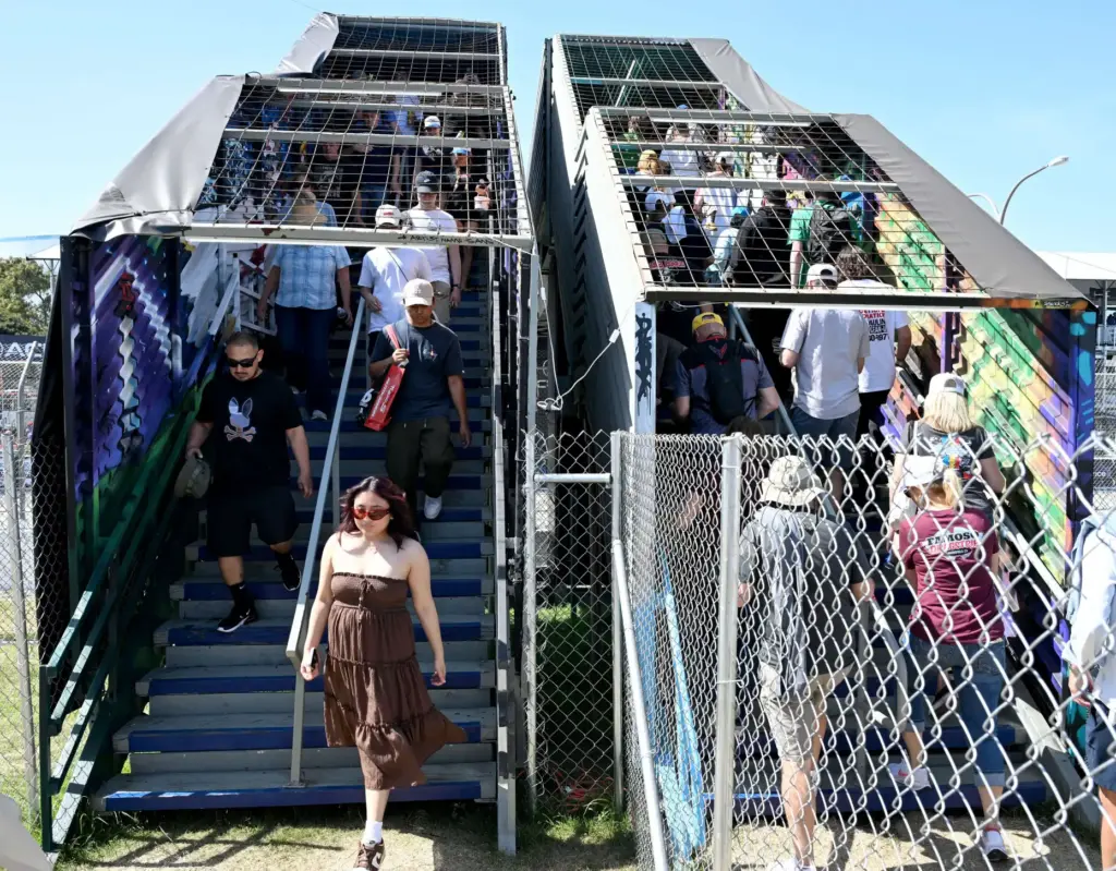 Race fans move along a pedestrian bridge during the 51st...