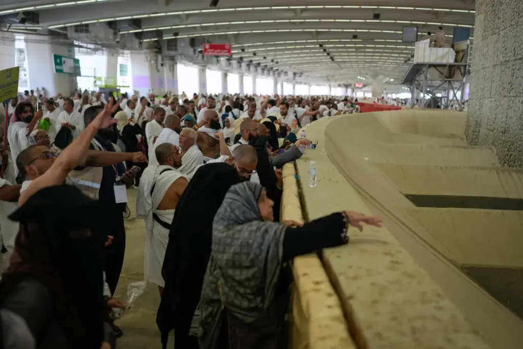 Muslim pilgrims pray after they cast pebbles at pillars in...