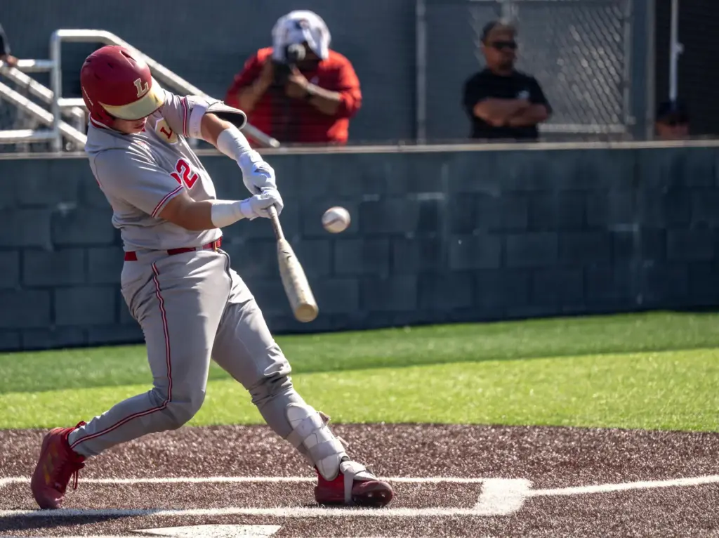 Orange Lutheran catcher Brady Murrietta hits the ball during a...