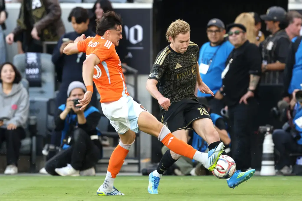 Los Angeles FC forward Jacob Shaffelburg, right, kicks the ball...