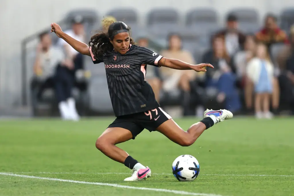 Angel City FC midfielder Taylor Suarez winds up to kick...