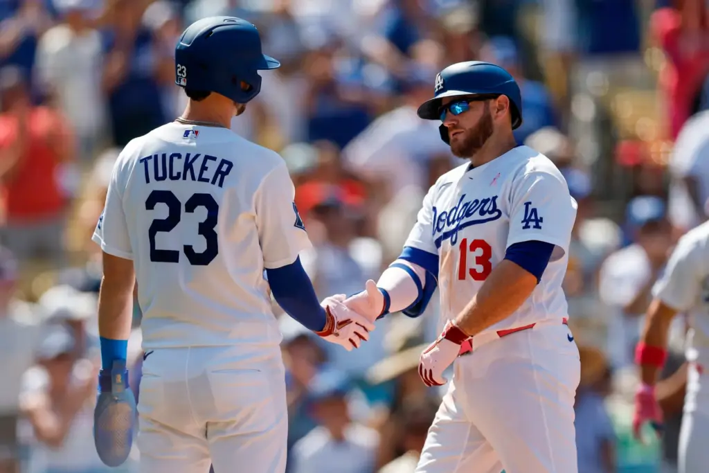 Dodgers’ Max Muncy (13) is greeted by Dodgers’ Kyle Tucker...