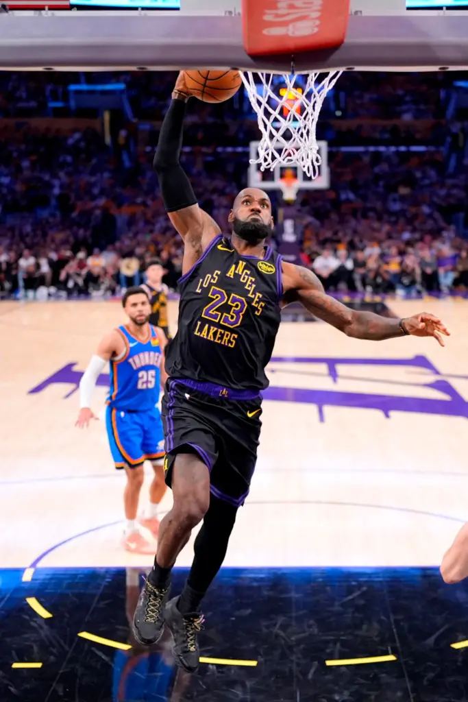Lakers forward LeBron James dunks as Oklahoma City Thunder guard...