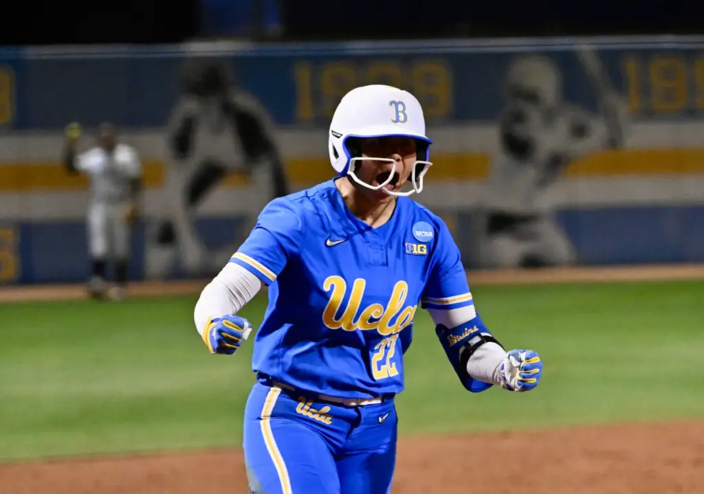 Bri Alejandre #22 of the UCLA Bruins reacts after hitting...