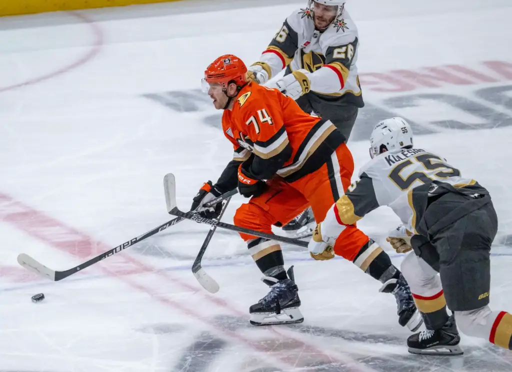 The Ducksâ John Carlson, left, controls the puck as the...