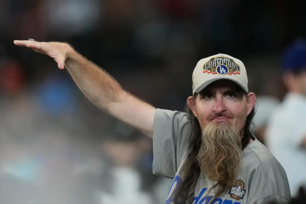 A Dodgers fan cheers during the ninth inning of a...