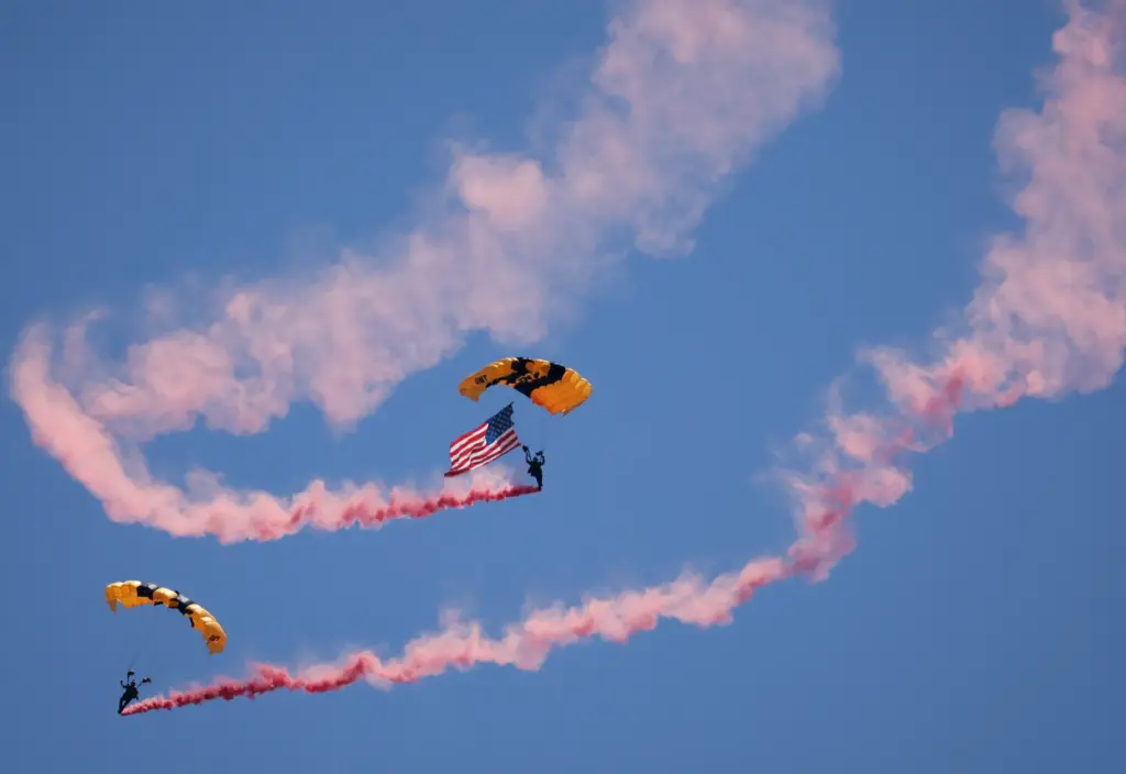 Members of the U.S. Army Golden Knights parachute onto the...