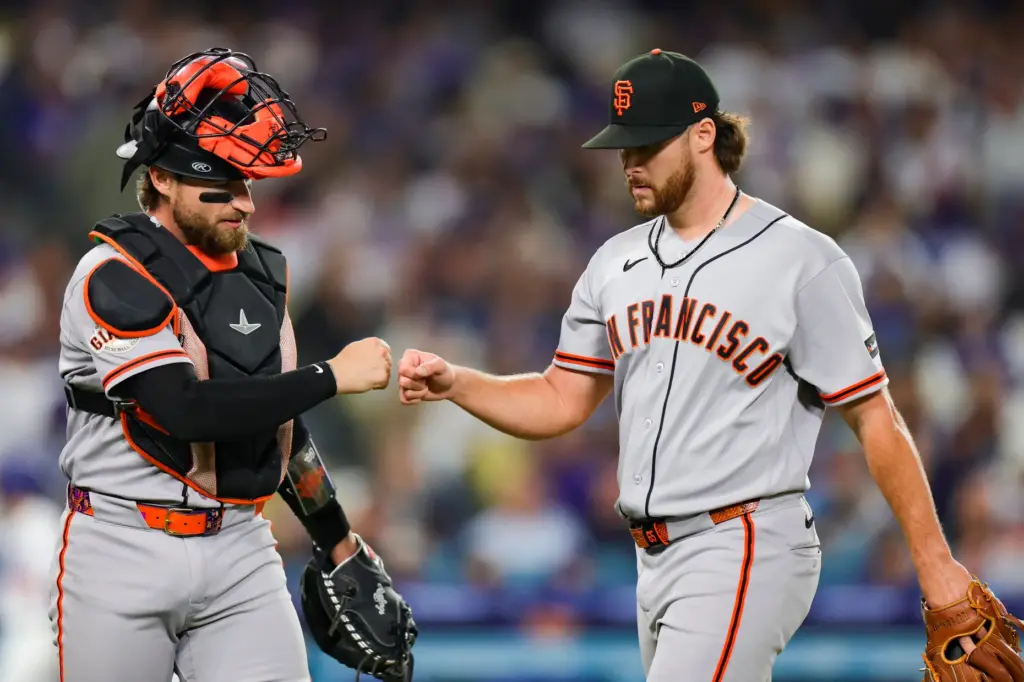 San Francisco Giants starting pitcher Landen Roupp, right, greets catcher...