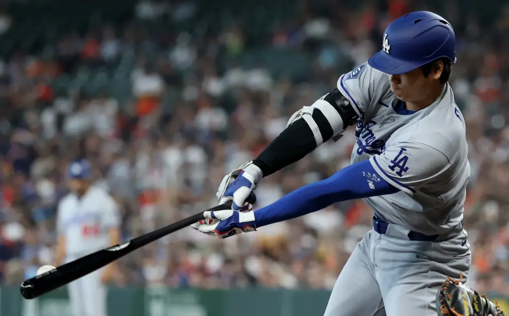 Dodgers star Shohei Ohtani hits a double during the third...