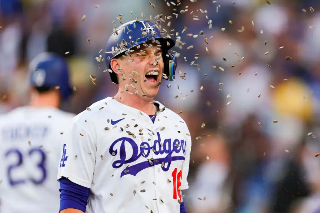 Dodgers designated hitter Will Smith is showered with sunflower seeds...