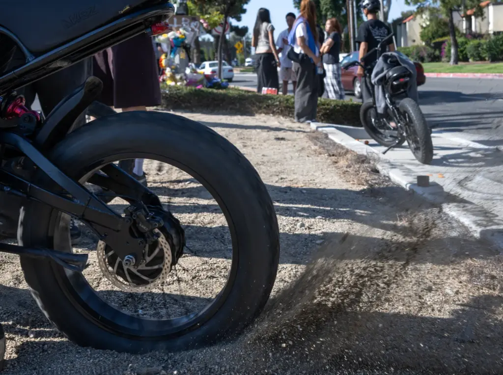 A mourner spins his rear tire at the accident site...