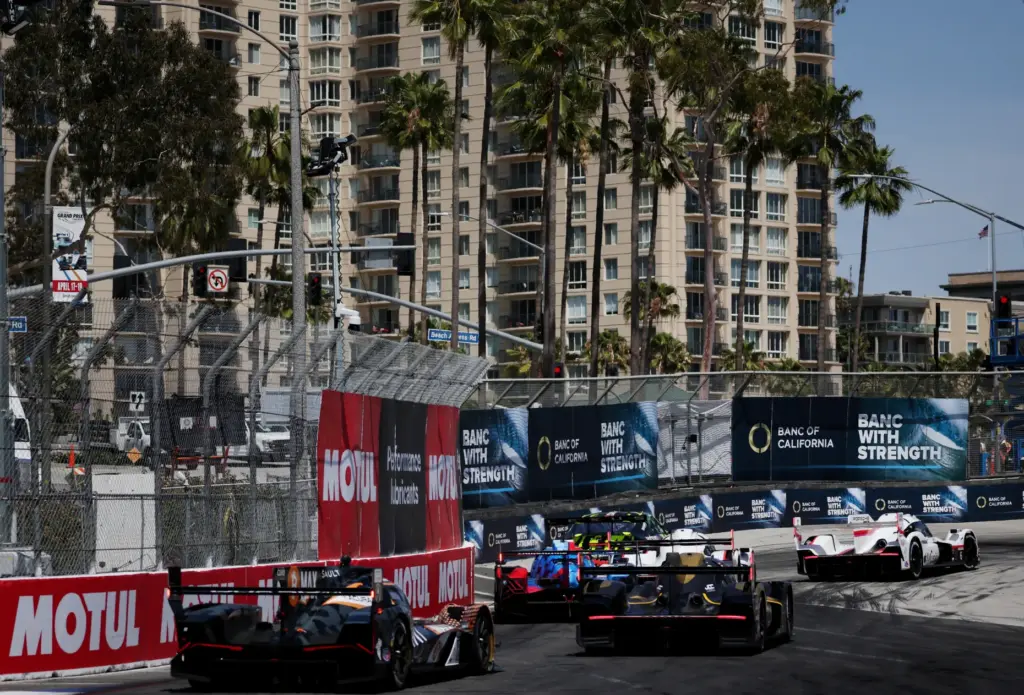 A group of GTP cars race into the hairpin in...
