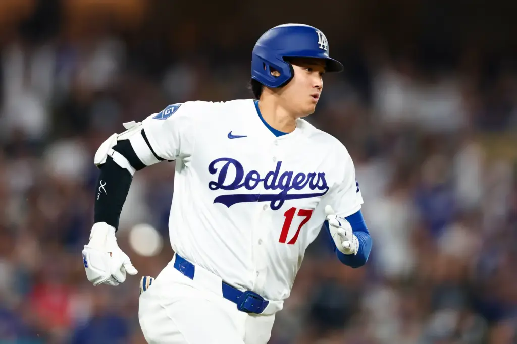 Dodgers star Shohei Ohtani runs after hitting an RBI single...