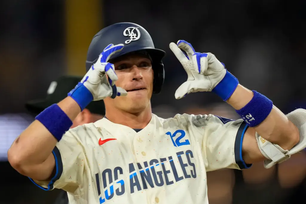Dodgers’ Alex Call gestures after hitting a triple during the...