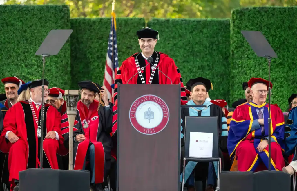 Chapman University President Matt Parlow speaks to graduates and their...