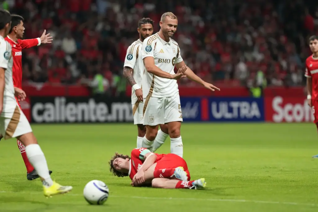 LAFC’s Ryan Porteous, center, reacts after he fouled Toluca FC’s...