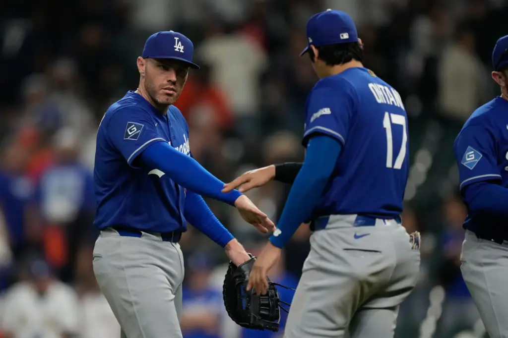 Dodgers first baseman Freddie Freeman, left, celebrates with designated hitter...